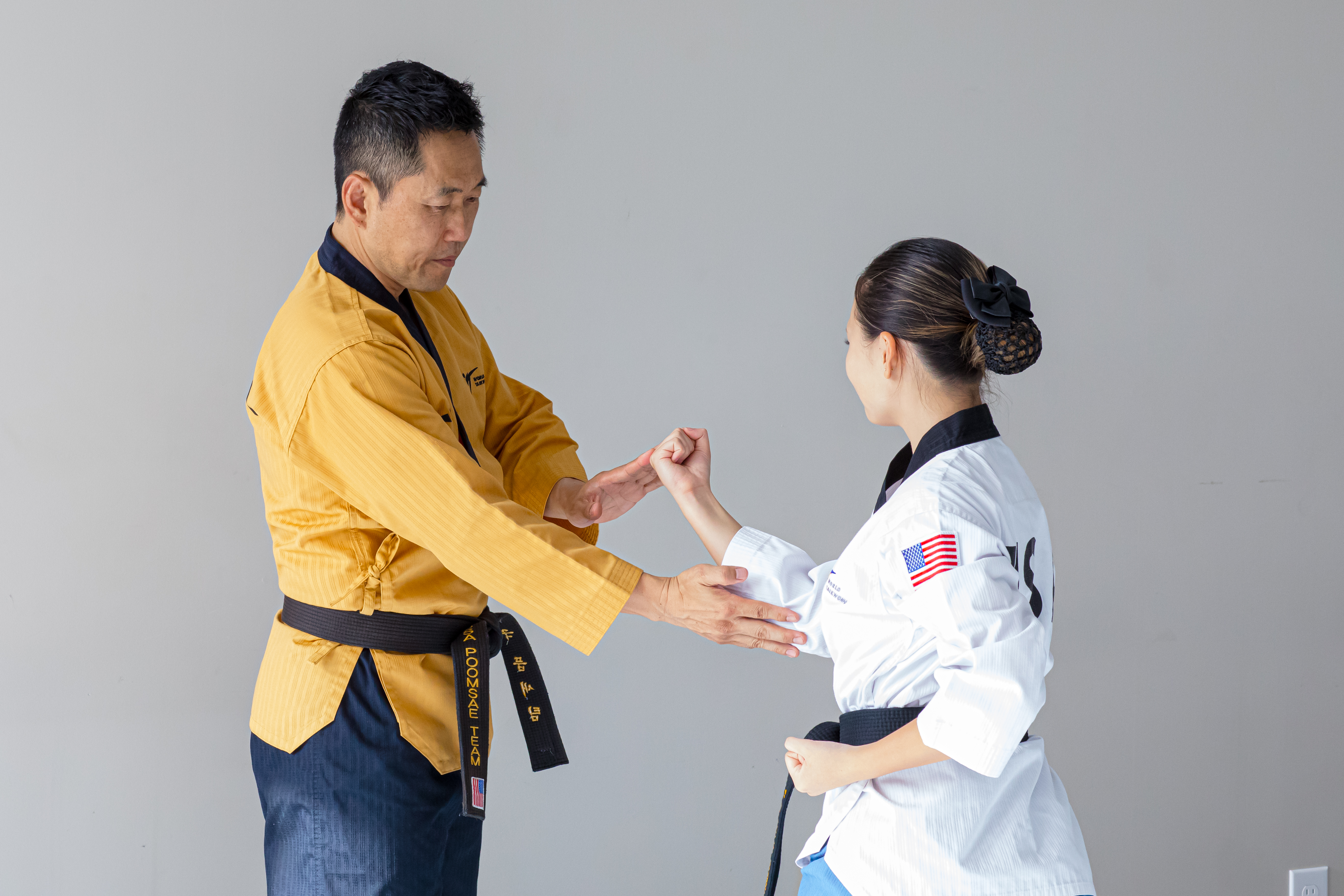 Adult and teen students practicing forms